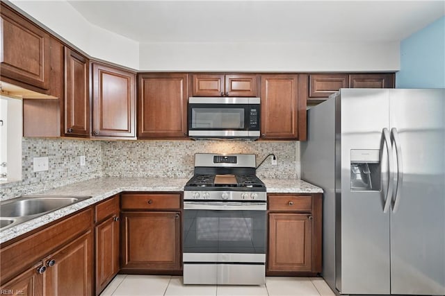 1405 Collingswood Trl, Virginia Beach, VA 23464 - kitchen with appliances with stainless steel finishes, decorative backsplash, light tile patterned floors, and brown cabinets