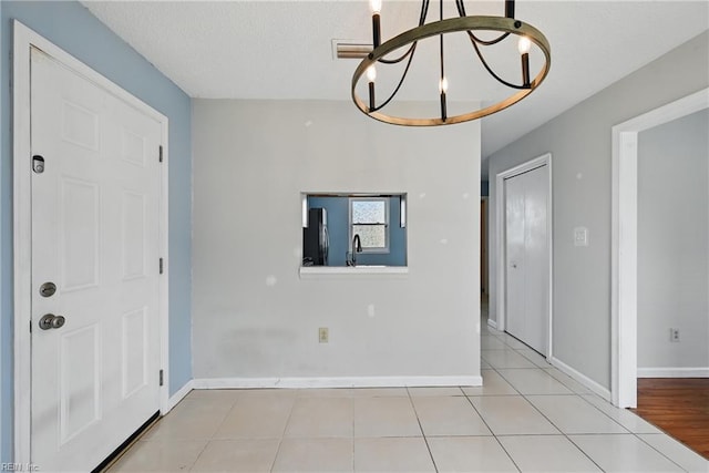 1405 Collingswood Trl, Virginia Beach, VA 23464 - tiled foyer featuring a chandelier, baseboards, and a textured ceiling