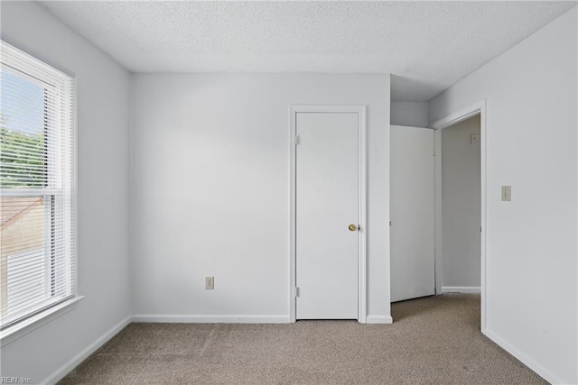 1405 Collingswood Trl, Virginia Beach, VA 23464 - unfurnished bedroom featuring carpet flooring, multiple windows, a textured ceiling, and baseboards