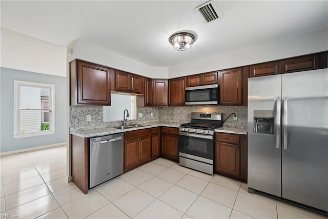 1405 Collingswood Trl, Virginia Beach, VA 23464 - kitchen featuring appliances with stainless steel finishes, a sink, tasteful backsplash, and light tile patterned floors