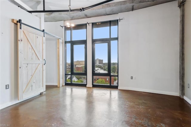 415 Saint Pauls Blvd Unit 609, Norfolk, VA 23510 - unfurnished room with finished concrete flooring, a barn door, baseboards, and a high ceiling