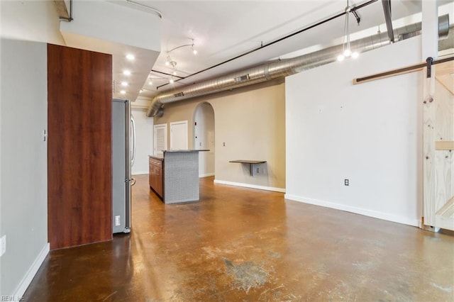 415 Saint Pauls Blvd Unit 609, Norfolk, VA 23510 - basement with arched walkways, freestanding refrigerator, a barn door, baseboards, and recessed lighting