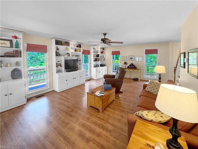 585 Morse Point Rd, Port Haywood, VA 23138 - living room with ceiling fan, wood finished floors, and stairway