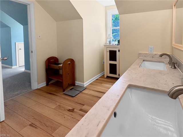 585 Morse Point Rd, Port Haywood, VA 23138 - bathroom featuring wood finished floors, double vanity, and baseboards
