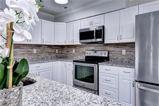 39 Morrison Ave, Newport News, VA 23601 - kitchen featuring appliances with stainless steel finishes, white cabinets, backsplash, and ornamental molding