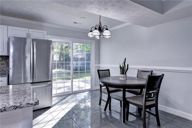 39 Morrison Ave, Newport News, VA 23601 - dining room with a textured ceiling, a chandelier, ornamental molding, marble finish floors, and baseboards
