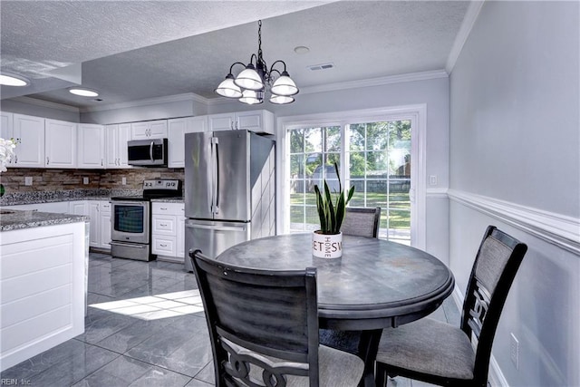 39 Morrison Ave, Newport News, VA 23601 - dining area with a textured ceiling, a chandelier, and ornamental molding