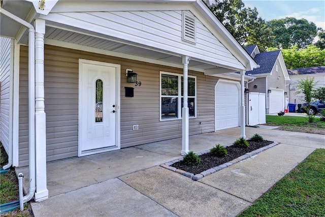 39 Morrison Ave, Newport News, VA 23601 - view of front facade with covered porch, an attached garage, and driveway