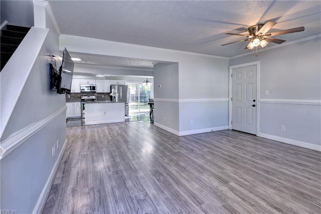 39 Morrison Ave, Newport News, VA 23601 - unfurnished living room featuring ceiling fan, crown molding, wood finished floors, baseboards, and a textured ceiling