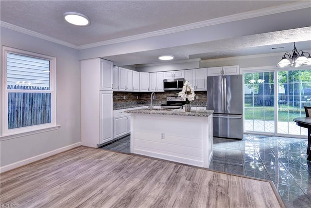 39 Morrison Ave, Newport News, VA 23601 - kitchen featuring stainless steel appliances, white cabinetry, wood finished floors, backsplash, and a chandelier
