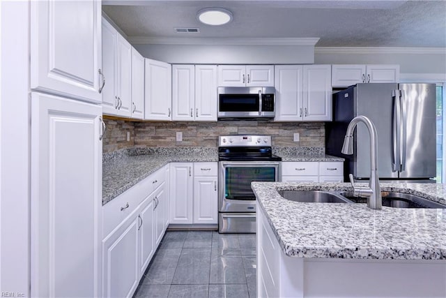 39 Morrison Ave, Newport News, VA 23601 - kitchen featuring stainless steel appliances, a sink, white cabinets, ornamental molding, and a textured ceiling