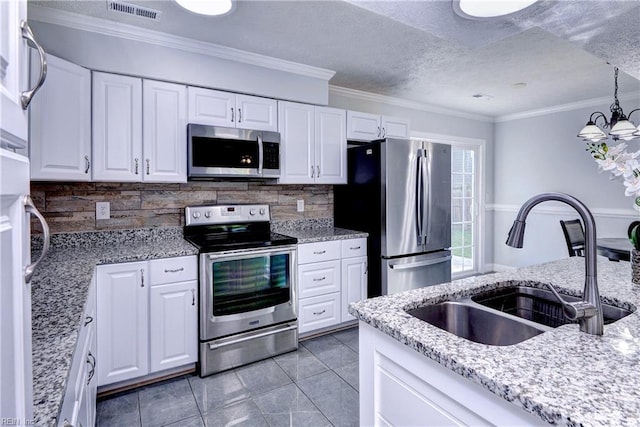 39 Morrison Ave, Newport News, VA 23601 - kitchen featuring appliances with stainless steel finishes, a sink, tasteful backsplash, white cabinets, and crown molding