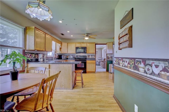 4217 Meadowgate Ct, Chesapeake, VA 23321 - kitchen with black appliances, plenty of natural light, light brown cabinetry, a peninsula, and recessed lighting