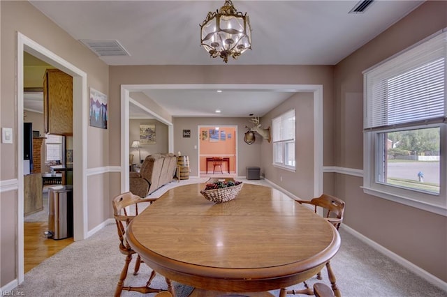 4217 Meadowgate Ct, Chesapeake, VA 23321 - dining room featuring light carpet, a chandelier, and baseboards