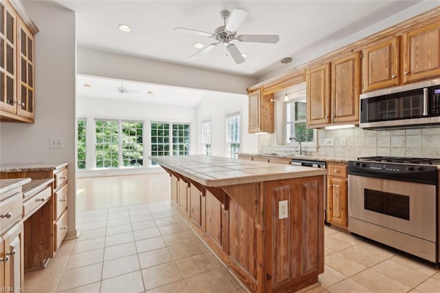 133 Sugar Bush, Williamsburg, VA 23188 - kitchen featuring stainless steel appliances, tasteful backsplash, light tile patterned floors, recessed lighting, and tile counters