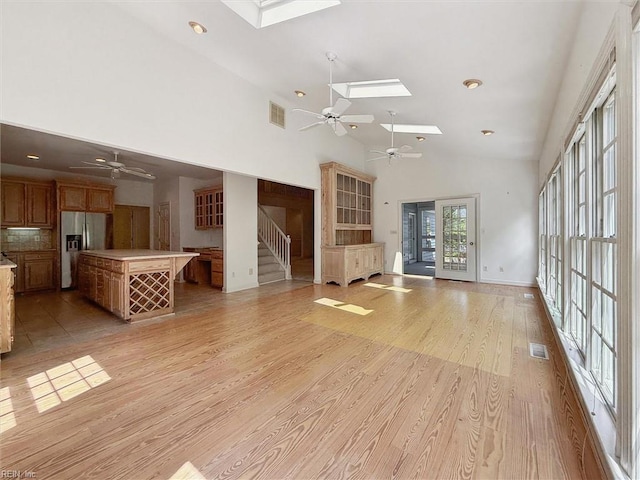 133 Sugar Bush, Williamsburg, VA 23188 - unfurnished living room featuring a skylight, ceiling fan, high vaulted ceiling, light wood finished floors, and recessed lighting