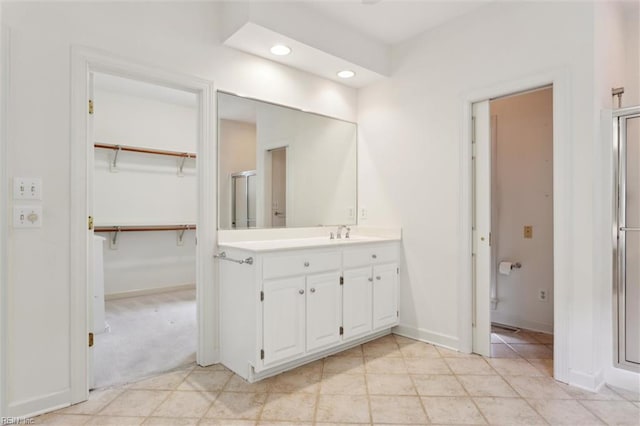 133 Sugar Bush, Williamsburg, VA 23188 - bathroom featuring vanity, baseboards, a stall shower, recessed lighting, and a spacious closet