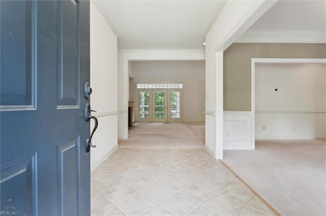 133 Sugar Bush, Williamsburg, VA 23188 - foyer featuring light colored carpet, crown molding, light tile patterned floors, and wainscoting