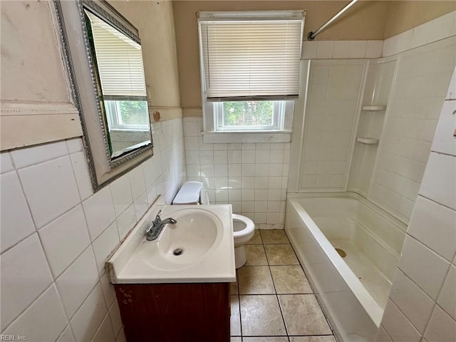 3860 Nansemond Cir, Norfolk, VA 23513 - bathroom with tile walls, toilet, vanity, tile patterned flooring, and washtub / shower combination