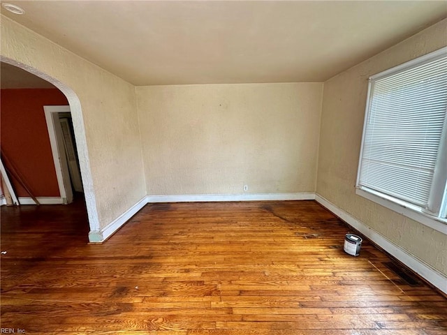 3860 Nansemond Cir, Norfolk, VA 23513 - unfurnished room with hardwood / wood-style flooring, arched walkways, and baseboards