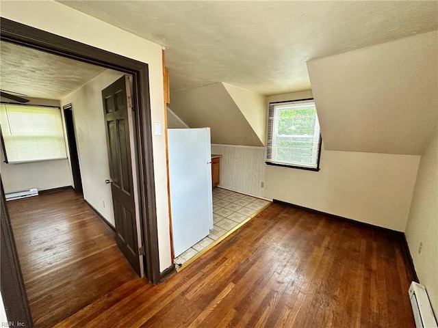 3860 Nansemond Cir, Norfolk, VA 23513 - bonus room with baseboard heating, hardwood / wood-style flooring, a baseboard radiator, baseboards, and lofted ceiling