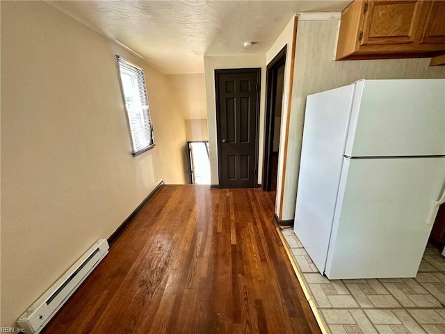3860 Nansemond Cir, Norfolk, VA 23513 - kitchen featuring freestanding refrigerator, a baseboard heating unit, light wood-type flooring, and brown cabinets
