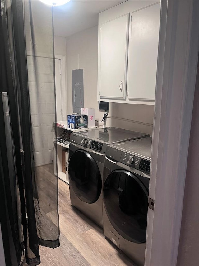 11 Greenwood Rd, Newport News, VA 23601 - laundry area featuring cabinet space, washing machine and clothes dryer, electric panel, and light wood-style floors