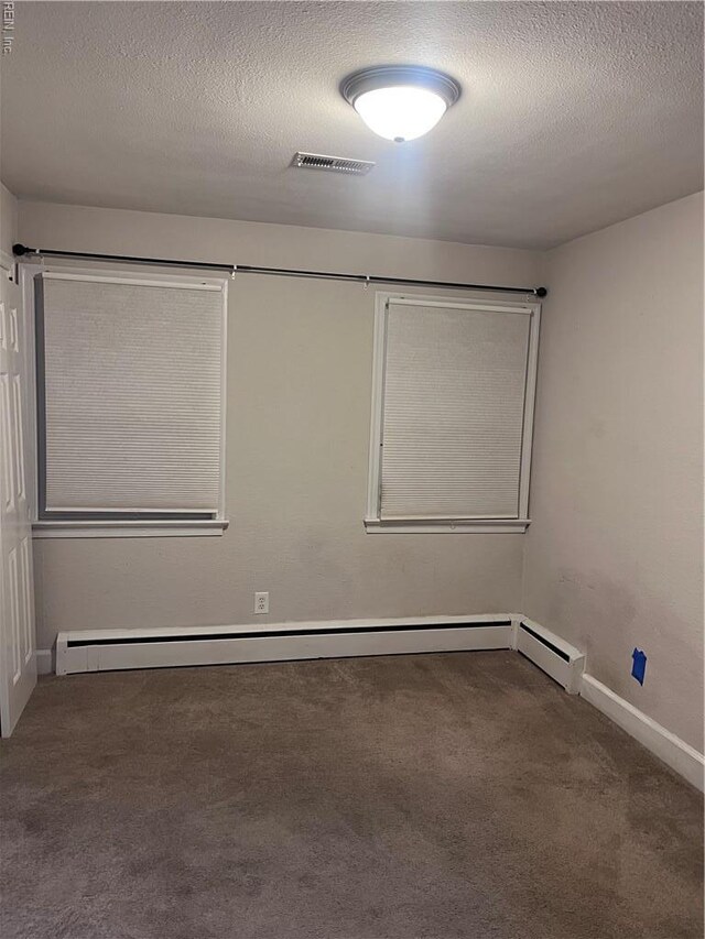 11 Greenwood Rd, Newport News, VA 23601 - carpeted spare room with baseboards, a textured ceiling, and a baseboard heating unit