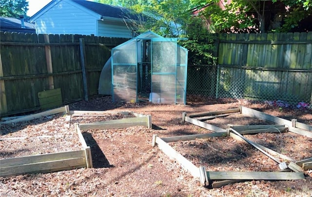 11 Greenwood Rd, Newport News, VA 23601 - fenced backyard with an exterior structure, a garden, and an outbuilding