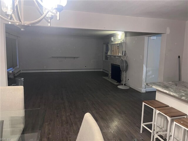 11 Greenwood Rd, Newport News, VA 23601 - unfurnished living room with wood finished floors, a fireplace, baseboards, and a chandelier
