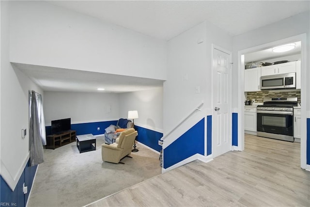 6628 Glenoak Dr, Norfolk, VA 23513 - living area with light wood finished floors, baseboards, and an upstairs landing