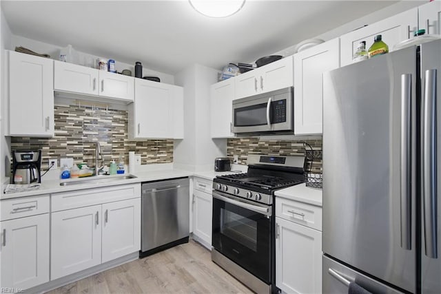 6628 Glenoak Dr, Norfolk, VA 23513 - kitchen featuring stainless steel appliances, a sink, light countertops, and white cabinetry