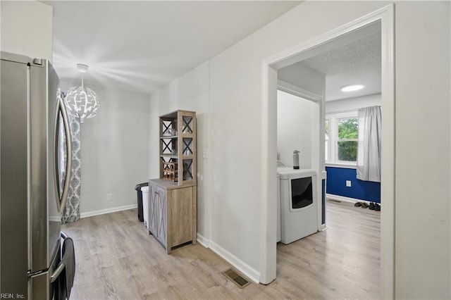 6628 Glenoak Dr, Norfolk, VA 23513 - laundry room featuring washer / dryer, light wood-type flooring, baseboards, and a chandelier