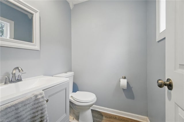 6628 Glenoak Dr, Norfolk, VA 23513 - bathroom with toilet, vanity, wood finished floors, and baseboards