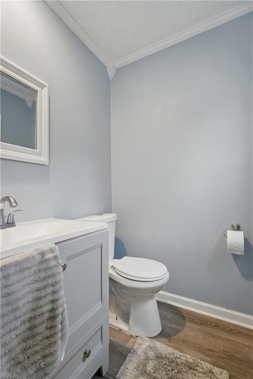 6628 Glenoak Dr, Norfolk, VA 23513 - half bath with crown molding, wood finished floors, toilet, vanity, and baseboards