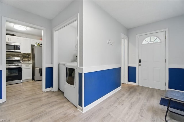 6628 Glenoak Dr, Norfolk, VA 23513 - entryway featuring washer and clothes dryer, light wood finished floors, and baseboards