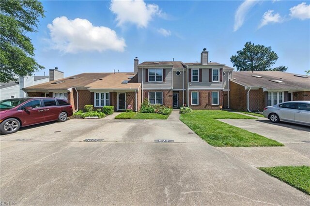 677 Hollomon Dr, Hampton, VA 23666 - multi unit property with brick siding, uncovered parking, a chimney, and a front yard