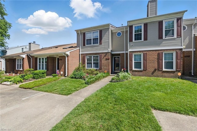 677 Hollomon Dr, Hampton, VA 23666 - multi unit property featuring brick siding, a chimney, and a front yard