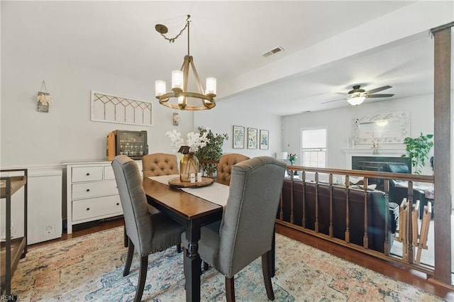 677 Hollomon Dr, Hampton, VA 23666 - dining space with wood finished floors, a chandelier, a fireplace, and ceiling fan