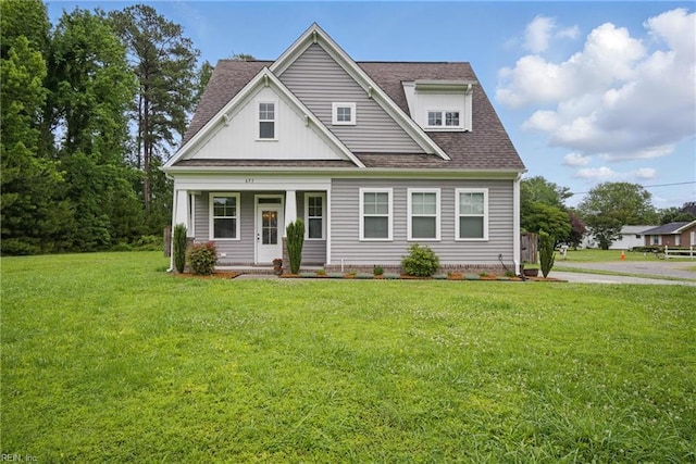 653 Waters Rd, Chesapeake, VA 23322 - view of front of home featuring covered porch, roof with shingles, a front yard, and board and batten siding