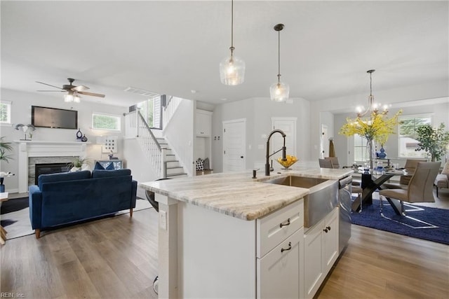 653 Waters Rd, Chesapeake, VA 23322 - kitchen featuring open floor plan, a sink, a ceiling fan, and light wood finished floors