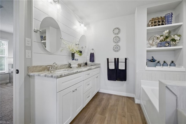 653 Waters Rd, Chesapeake, VA 23322 - full bathroom with double vanity, a bath, wood finished floors, and baseboards