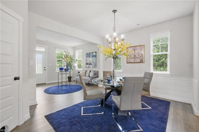 653 Waters Rd, Chesapeake, VA 23322 - dining area featuring a chandelier, wood finished floors, and a wainscoted wall