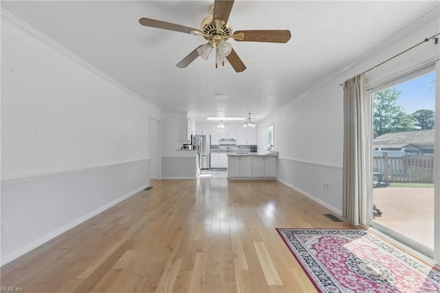 5 Still Harbor Ct, Hampton, VA 23669 - unfurnished living room featuring light wood-style floors, a ceiling fan, baseboards, crown molding, and a chandelier