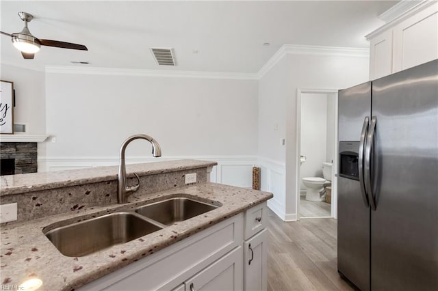 23 Mallory Way, Hampton, VA 23664 - kitchen featuring stainless steel fridge, a sink, ornamental molding, light wood-type flooring, and white cabinetry