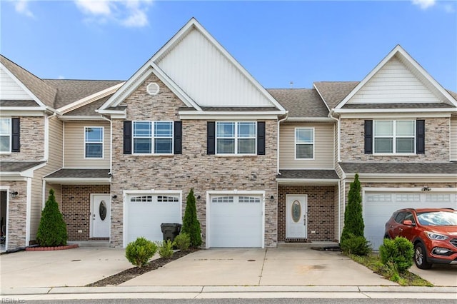 23 Mallory Way, Hampton, VA 23664 - view of property featuring driveway, board and batten siding, an attached garage, stone siding, and a shingled roof