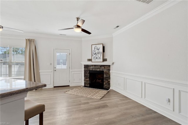 23 Mallory Way, Hampton, VA 23664 - living room featuring ceiling fan, crown molding, wainscoting, a decorative wall, and light wood-type flooring