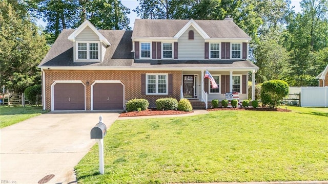 1020 Baydon Ln, Chesapeake, VA 23322 - colonial home with covered porch, concrete driveway, an attached garage, and brick siding