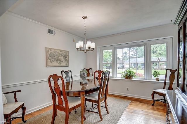1052 Sunnyside Dr, Virginia Beach, VA 23464 - dining space featuring light wood-type flooring, ornamental molding, a chandelier, and baseboards