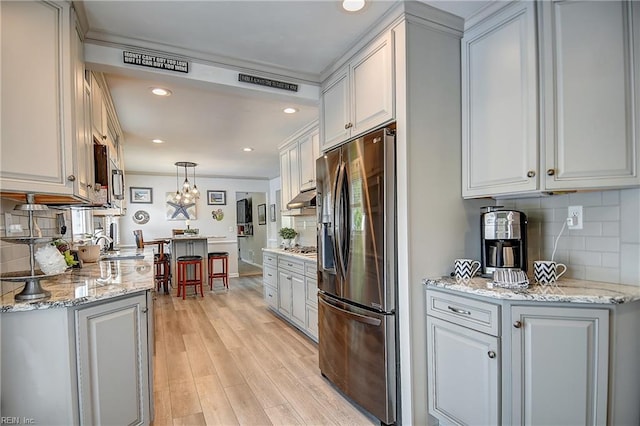 1052 Sunnyside Dr, Virginia Beach, VA 23464 - kitchen featuring appliances with stainless steel finishes, under cabinet range hood, backsplash, ornamental molding, and recessed lighting